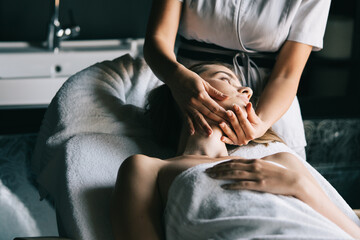 Obraz na płótnie Canvas Healthy woman having massage therapy at spa salon