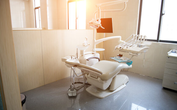 Modern dentistry office interior with chair and tools.