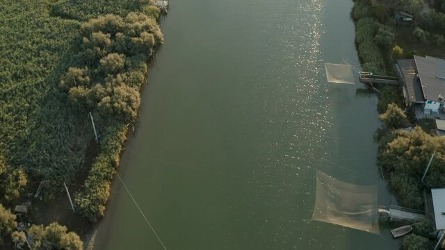 Aerial view of the fishing huts in the river that flows into the Adriatic sea, Lido di Dante, Fiumi Uniti, Ravenna near Comacchio valley.