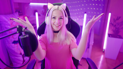 Cute gamer girl streamer with cat ear headphones make a mind blown gesture