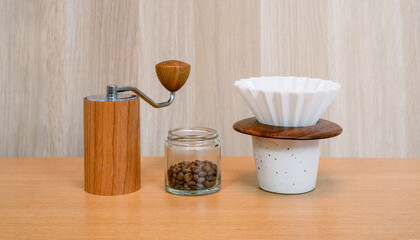 Coffee brewing equipment, Dripper set on a wooden table, Making home coffee concept. Wooden manual hand grinder and Ceramic dripper