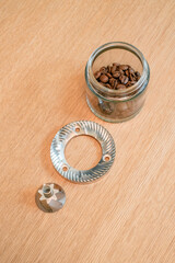 Coffee Burr Grinder flat and conical stainless steel burr on wooden background