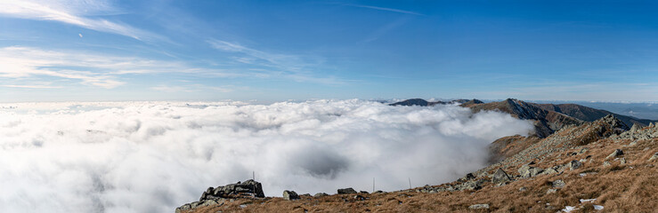 Panoramic view from the tops of the mountains to the inverse clouds. 