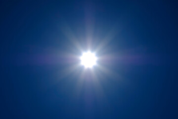 Fototapeta premium The sun's rays spreading across the cloudless sky. No land image.