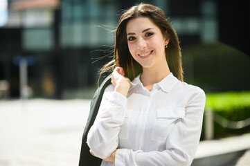 Confident young female manager outdoor in a modern urban setting