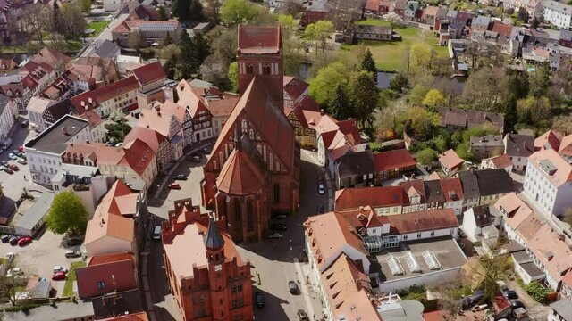 Aerial view in a sightseeing flight of Perleberg in Brandenburg Germany. You can see the old town with the town hall and the church. The roofs are covered with red tiles