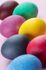 Fototapeta na wymiar Colorful Easter eggs as an attribute of Easter celebration. Pink background.