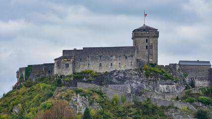 Lourdes, France - 9 Oct 2021: The Chateau Fort de Lourdes overlooking the town and Rosary Basilica