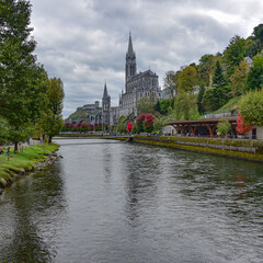 Lourdes, France - 9 Oct 2021: Views of the Rosary Basilica Church from the Gave de Pau river in Lourdes
