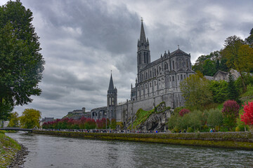 Lourdes, France - 9 Oct 2021: Views of the Rosary Basilica Church from the Gave de Pau river in Lourdes