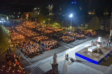 Lourdes, France - 9 Oct 2021: Pilgrims attend the Marian Torchlight Procession service at the...
