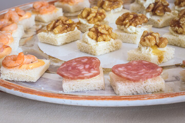 Fototapeta na wymiar Assorted Canapés Appetizers On A Decorated Plate
