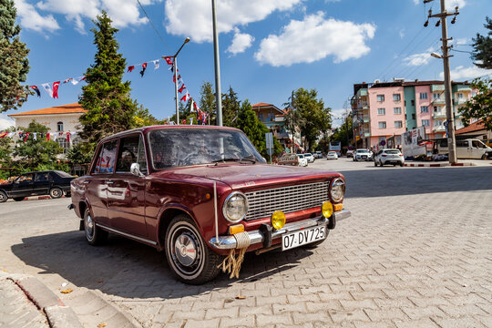 Old, Red colored Classical Car made by Fiat and Tofas in Turkey named Murat 124, Tofas Serce (sparrow) parked.