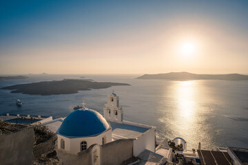 Traditional blue dome church and white bell tower in Santorini in Greece