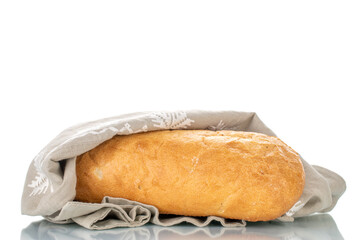 One fragrant ciabatta with a linen napkin, close-up, isolated on white.
