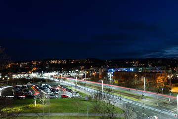 Fototapeta premium colorful light stripes of cars on the street at night in front of a church in the city of plauen