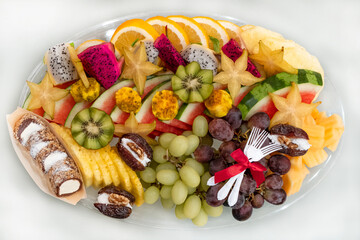 Fruit platter with fresh grapes,watermelon, melon, pineapple, kiwi. Top view above table. Colorful Fruit mix tray is the best health good food for a party and a holiday table..