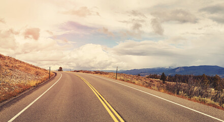 Scenic road in Grand Teton National Park, color toning applied, Wyoming, USA.
