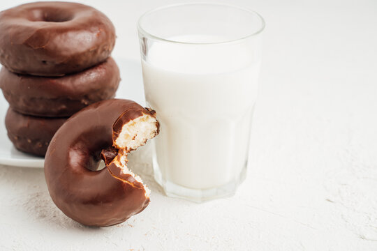 Delicious doughnuts with chocolate near milk
