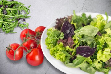 Green salad with greens and tomatoes. Healthy vegan dish.