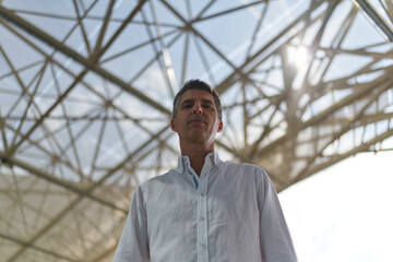 portrait of a person with a metal structure behind him