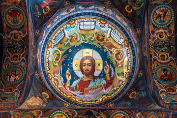 Fototapeta na wymiar The interior of the Church of the Savior on Blood. Central mosaic image of Christ Pantokrator in the plafond of the central dome. Saint-Petersburg, Russia
