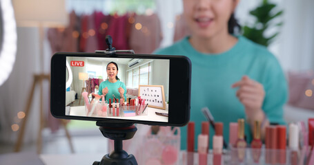 Asia woman micro influencer record live viral video camera at home studio. Happy fun talk speak...