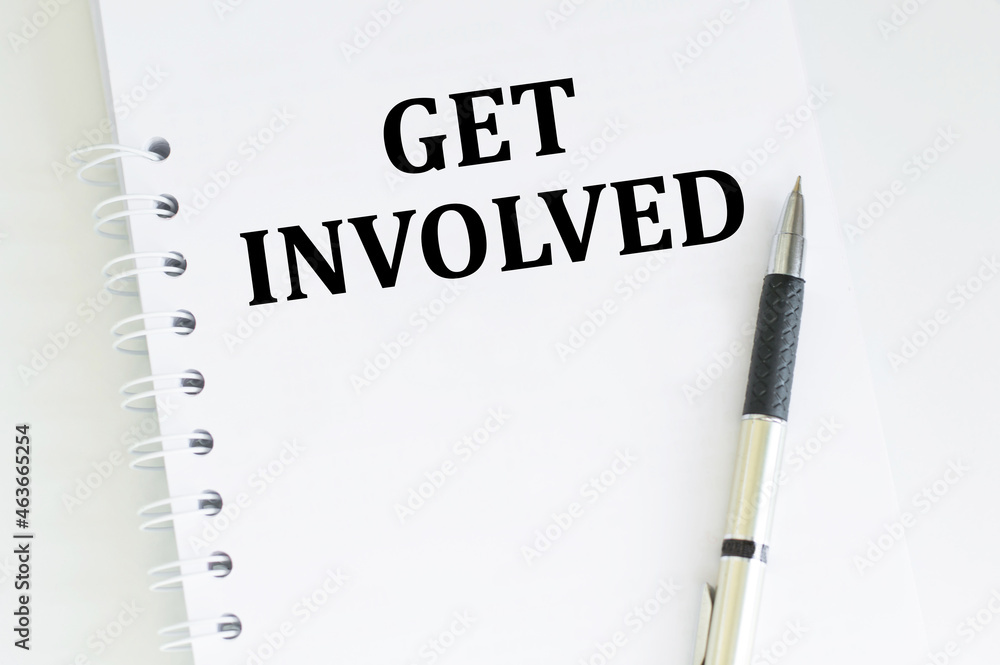 Poster get involved text written on notebook page, next to a pen. motivation concept image