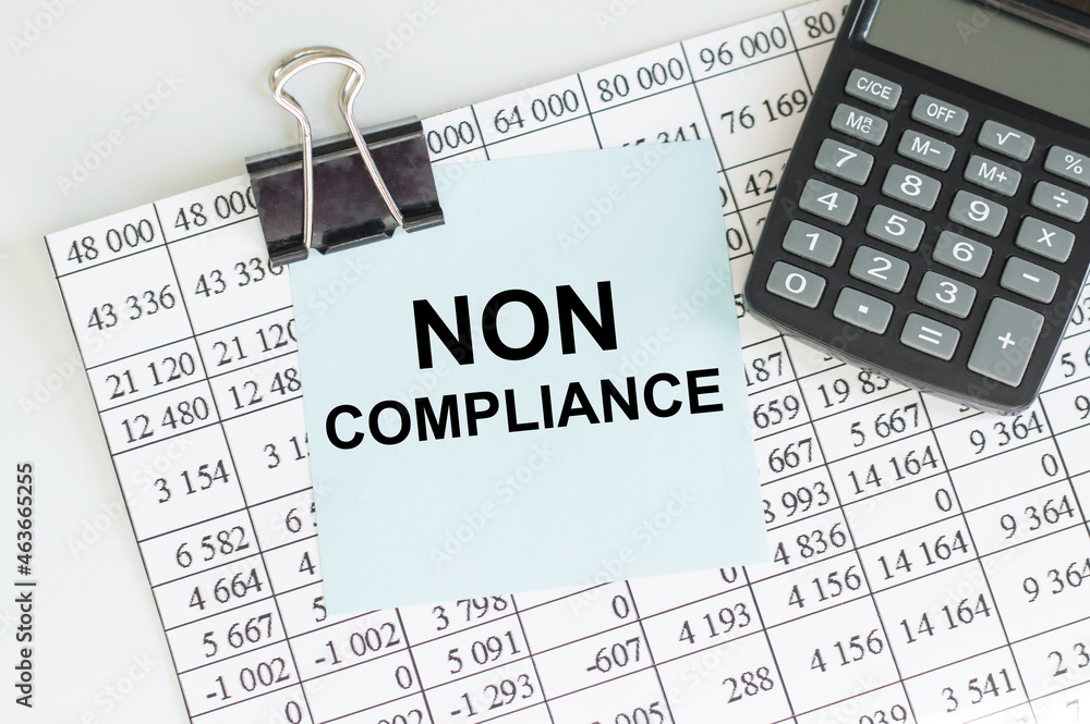 Poster text non compliance in the blue short note paper on the background of a sheet with numbers next to a