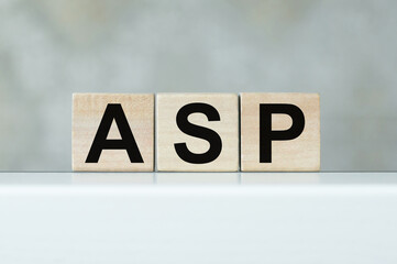 Wood cubes with acronym ASP on the light table Business concept with copy space.