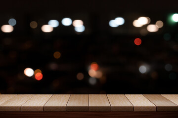 Empty brown wooden table and night light bokeh blurred restaurant background. For display your product.