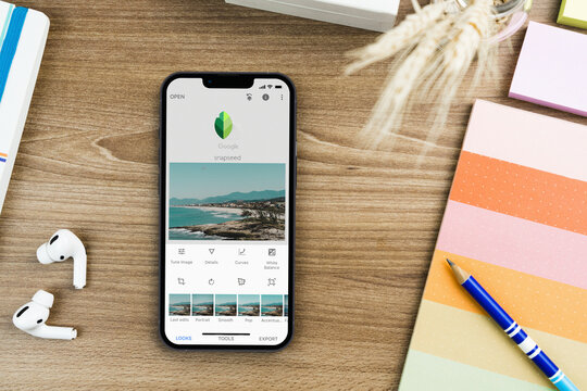 Google Snapseed Mobile app on iPhone 13 Pro smartphone  screen on wooden table with other accessories. Rio de Janeiro, RJ, Brazil. October 2021.