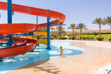 Hurghada, Red Sea Governorate, Egypt 17.09.2021: little girl stands in the middle of the pool of...