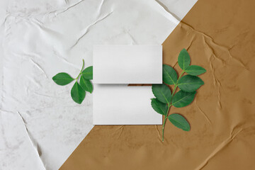 Clean minimal business card mockup on glued paper with leaves