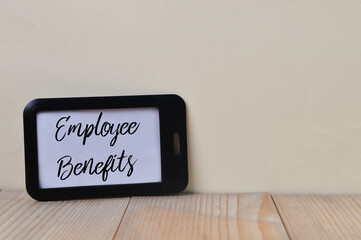 Black name tag written with text EMPLOYEE BENEFITS