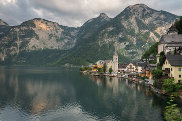 Panoramic view of famous old town Hallstatt and alpine deep blue lake in scenic sunset light on a beautiful day in summer, Salzkammergut, Austria