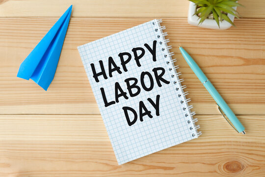 Labor Day sign on notepad and wooden background