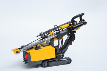 Natural scale model of a contour drill rig on a white background