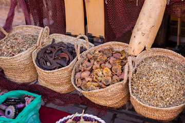 Morrocan local market on the streets with spices, nuts, fish, fruits and vegetables.