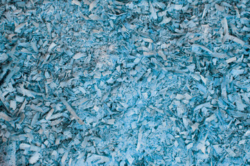 wood sawdust. shavings from boards. blue background. grooved surface