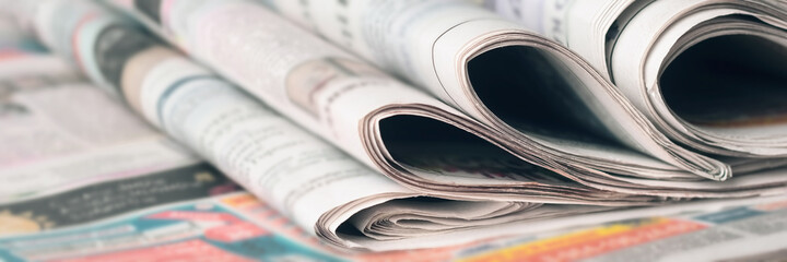 Panoramic image of old newspapers. Blur, selective focus.