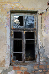 Fototapeta na wymiar Broken window in an old abandoned house