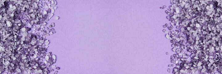Purple bath salt crystals close-up background banner with copy space.