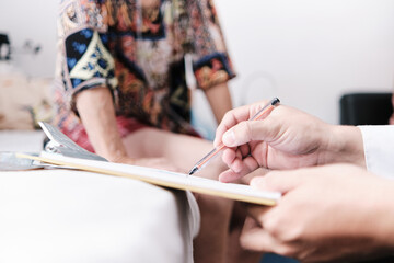 physician writing prescriptions at the patient's home