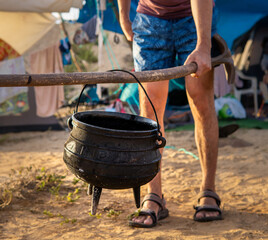 poyke pot. campfire cauldron cooking. making food outside on fire site. shot in israel near hedera...