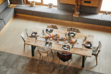 High angle view of served dining table decorated in autumn design in the biig dining room