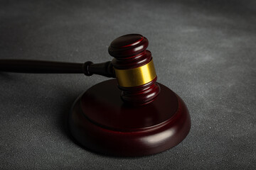 Law theme, mallet of the judge on wooden desk with Lady Justice Statue. Law gavel on dark foggy...