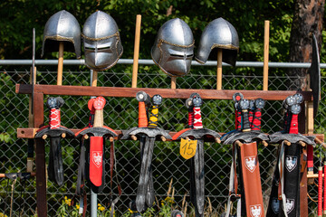 Toys for playing Polish knights: wooden swords with the coat of arms of Poland and helmets