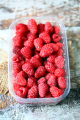 Fresh raspberries in a tray. Organic food.