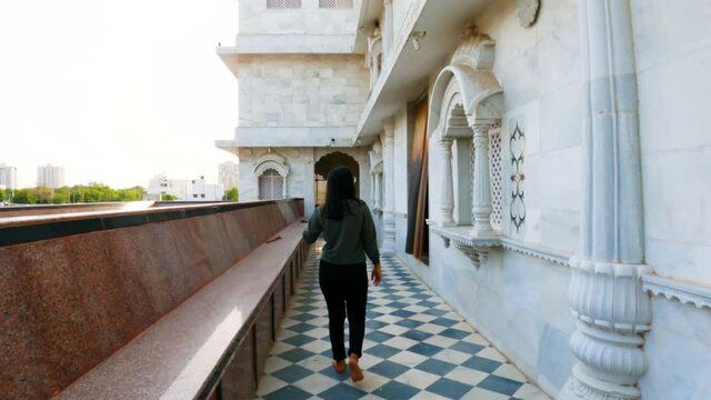 4k video of Indian young woman walking in Iskcon temple at Rajkot